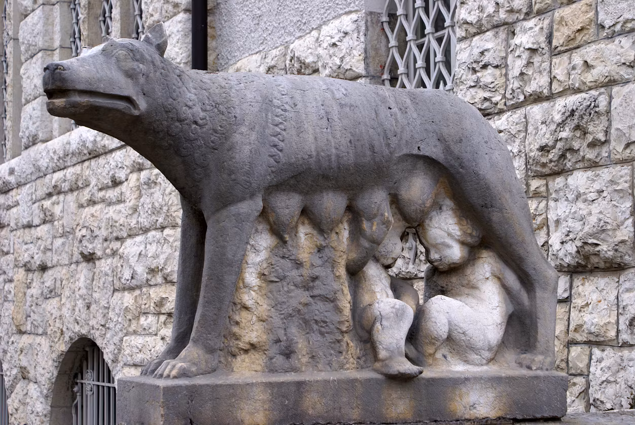 Eine steinerne Skulptur der Wölfin Eine steinerne Skulptur der Wölfin mit zwei Kindern