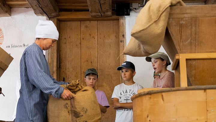 Führung einer Schulklasse durch die historische Mühle auf dem Gelände von Schloss Hallwyl.