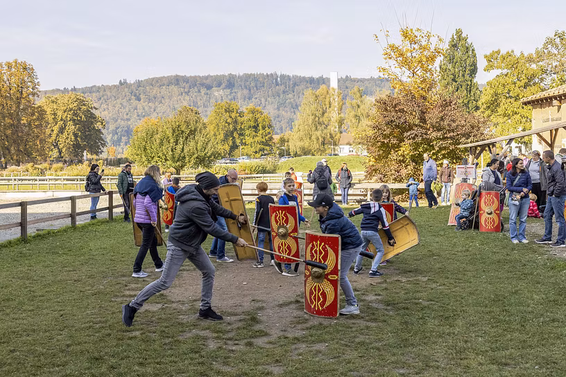 Familien kämpfen auf einer Wiese im Legionärspfad gegeneinander wie die Römer.
