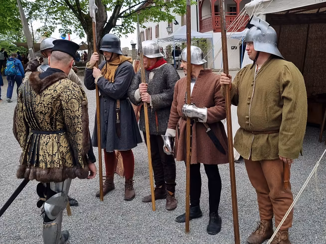 Mehrere Männer mit Rüstung und Hellebarde