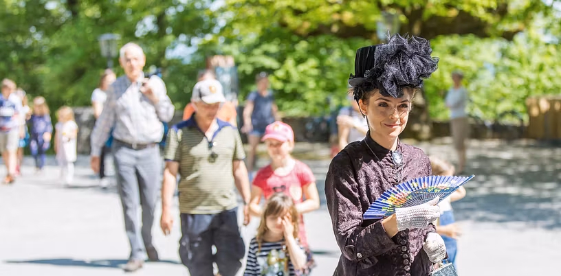 Als Sisi verkleidete Führerin vor einer Gruppe auf Schloss Habsburg